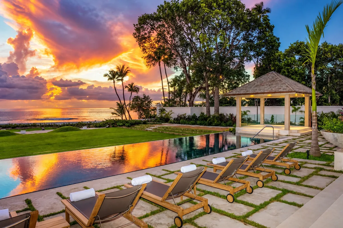 Sunset over an oceanfront infinity pool and loungers in Barbados
